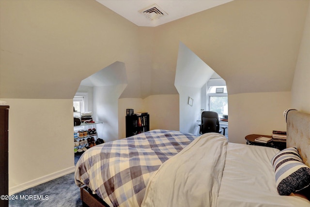 bedroom featuring carpet flooring and vaulted ceiling