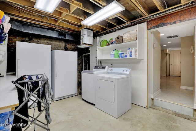 washroom with washing machine and clothes dryer