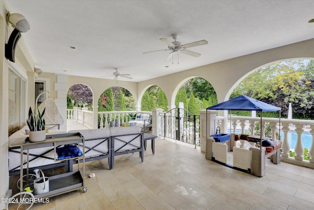 view of patio with a pool, ceiling fan, and an outdoor hangout area