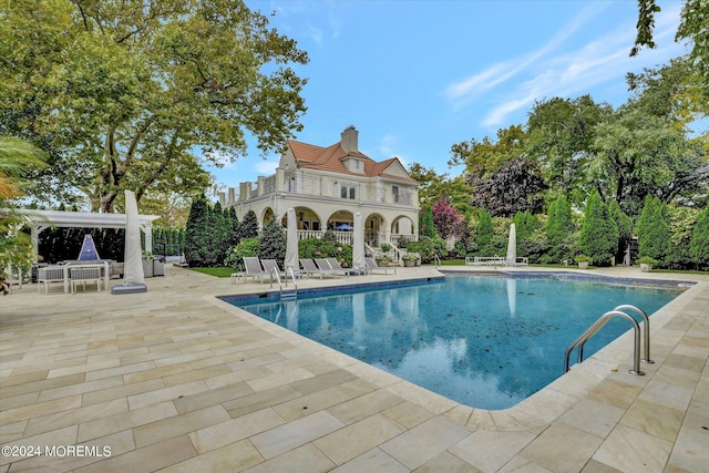 view of swimming pool with a patio and a gazebo