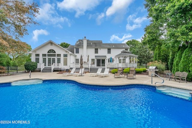 view of pool featuring area for grilling, a patio area, and french doors