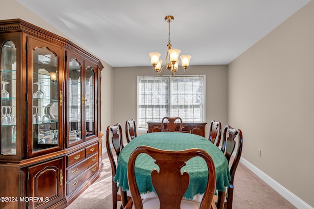 dining room with light carpet and a notable chandelier