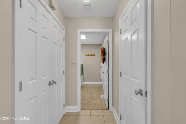 hall with light tile patterned floors