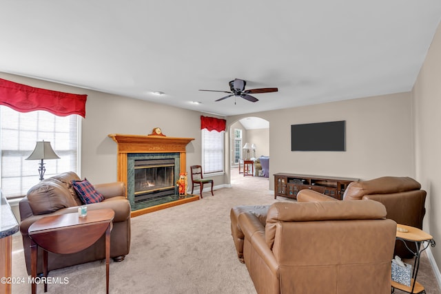 living room with light colored carpet, a fireplace, and a wealth of natural light