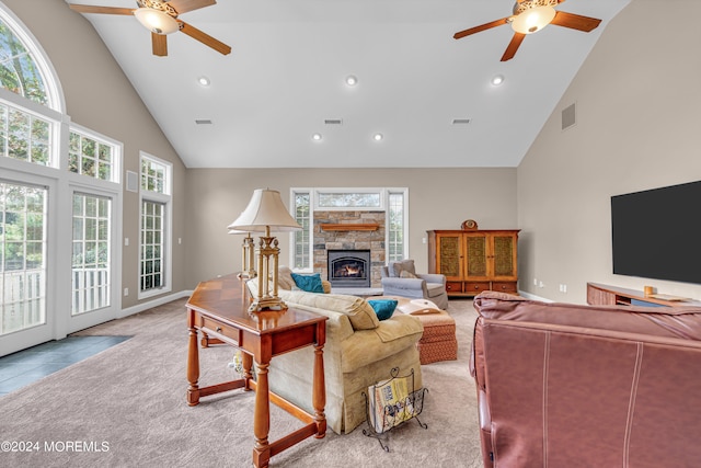 carpeted living room with high vaulted ceiling, ceiling fan, and a fireplace