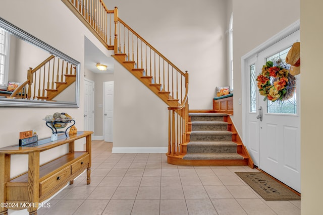 tiled foyer featuring a towering ceiling