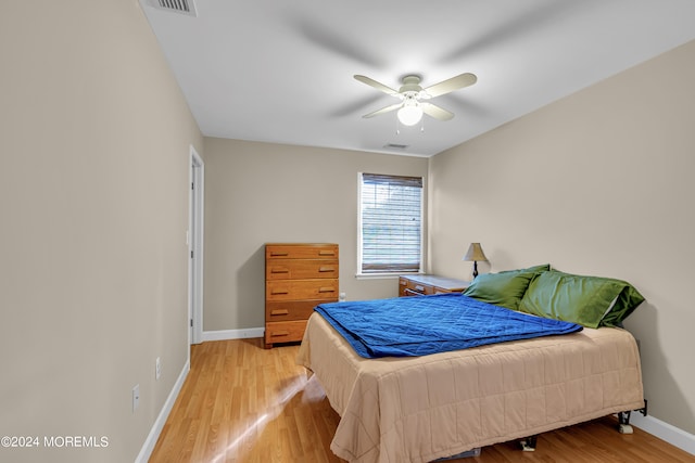 bedroom with light hardwood / wood-style flooring and ceiling fan