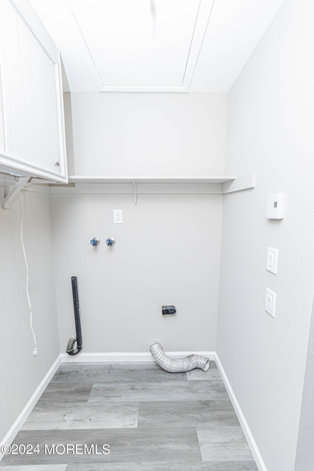 laundry room with cabinets and light hardwood / wood-style flooring