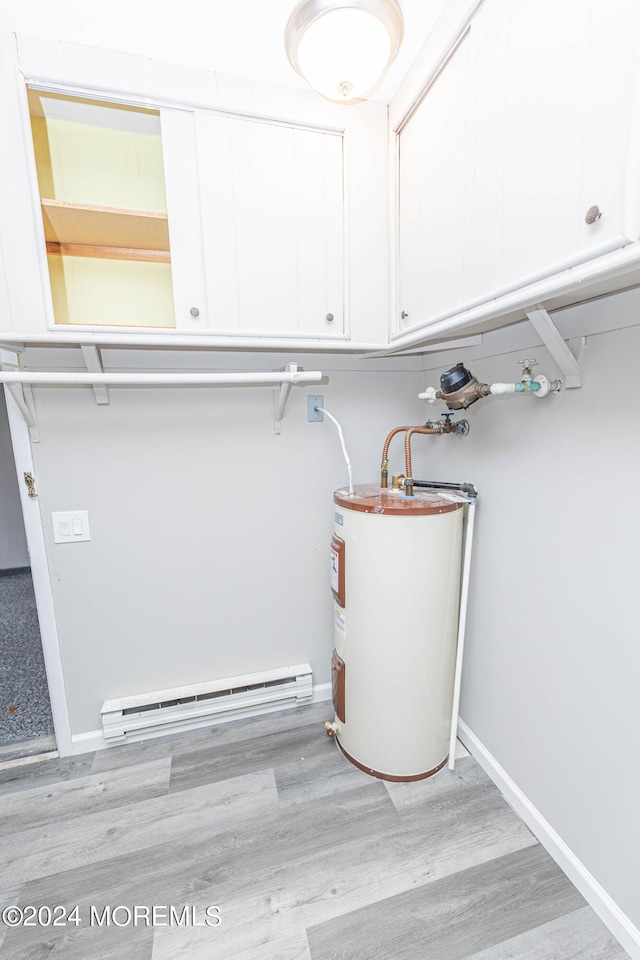 interior space with water heater and a baseboard radiator