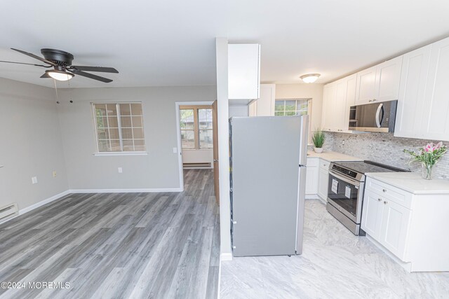 kitchen with white cabinetry, a ceiling fan, appliances with stainless steel finishes, and light countertops
