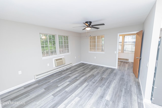 unfurnished room with ceiling fan, light wood-style floors, a healthy amount of sunlight, and a baseboard radiator