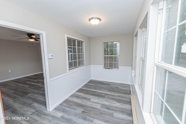 unfurnished sunroom with ceiling fan