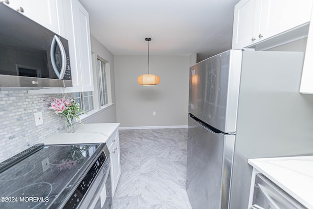 kitchen featuring light stone countertops, tasteful backsplash, stainless steel appliances, marble finish floor, and white cabinetry