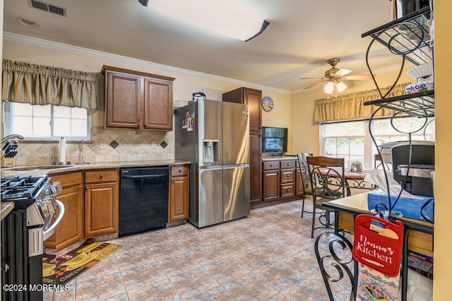 kitchen featuring ceiling fan, sink, ornamental molding, tasteful backsplash, and stainless steel appliances