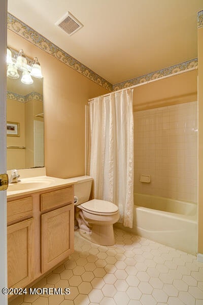 full bathroom featuring shower / tub combo, vanity, toilet, and tile patterned floors