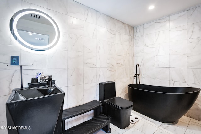 bathroom featuring a bath, sink, toilet, and tile walls