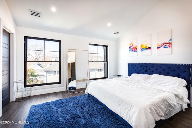 bedroom featuring lofted ceiling and dark hardwood / wood-style floors