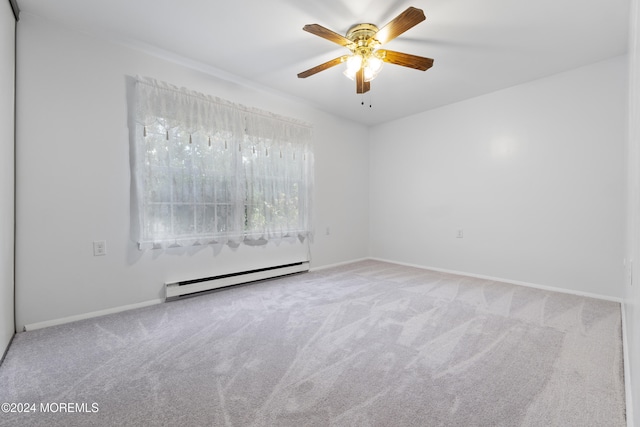 carpeted spare room with ceiling fan and a baseboard radiator