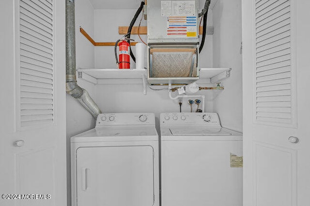 washroom with heating unit and washer and dryer