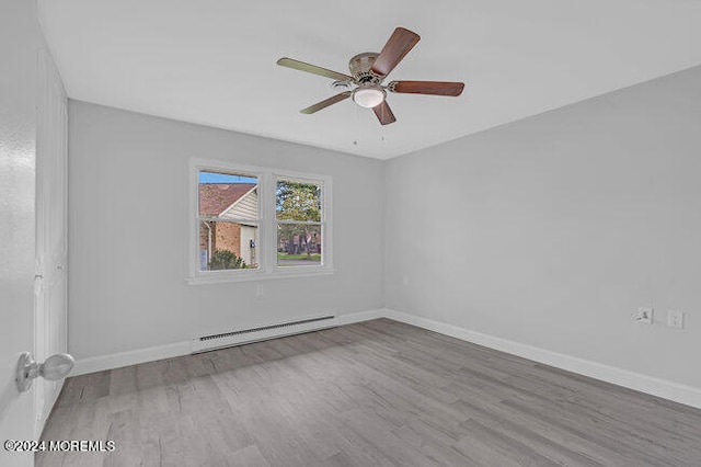 empty room featuring light hardwood / wood-style floors, ceiling fan, and a baseboard radiator