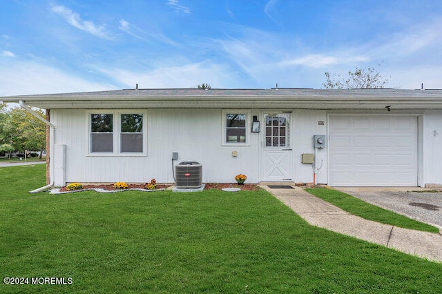 ranch-style house with a front lawn, central AC unit, and a garage