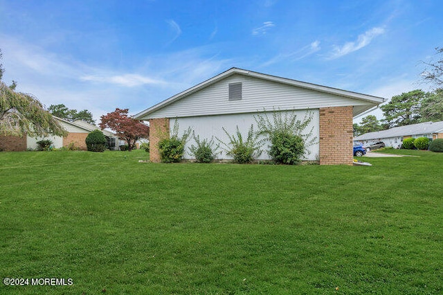 view of side of home featuring a lawn