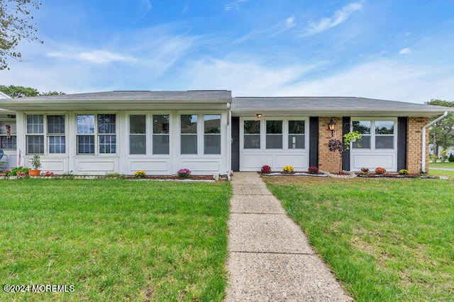 ranch-style home featuring a front yard