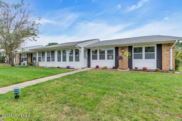 ranch-style home with a front yard