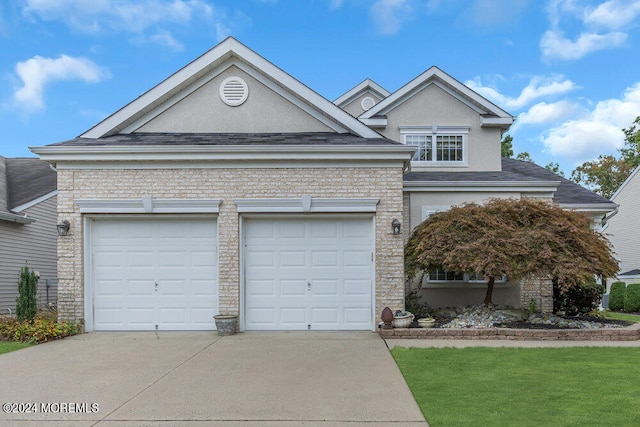 view of front facade with a front yard and a garage