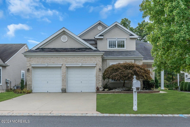 view of front of home featuring a garage and a front lawn