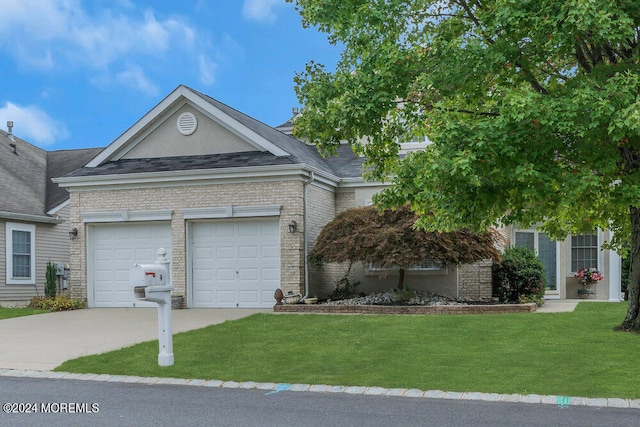 view of front facade with a garage and a front lawn