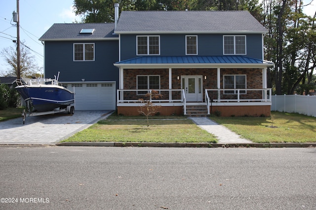 view of front property featuring a front yard, a porch, and a garage