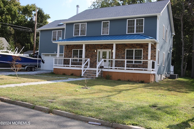 view of front facade with a garage, a front lawn, covered porch, and central air condition unit