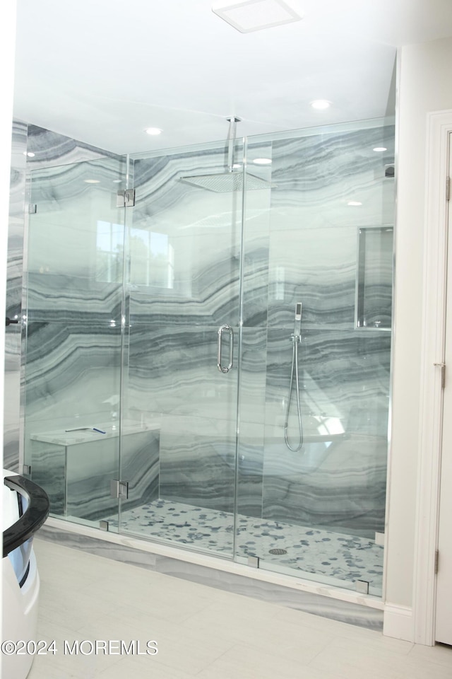 bathroom featuring an enclosed shower and tile patterned floors