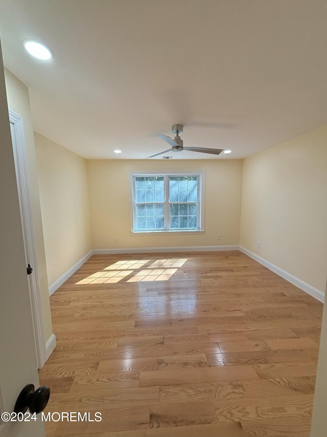 spare room featuring ceiling fan and light hardwood / wood-style flooring