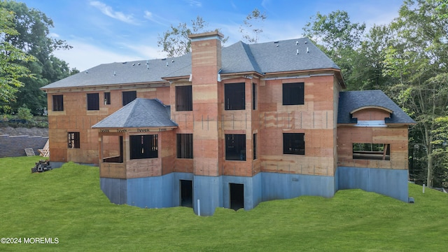 rear view of house with a lawn