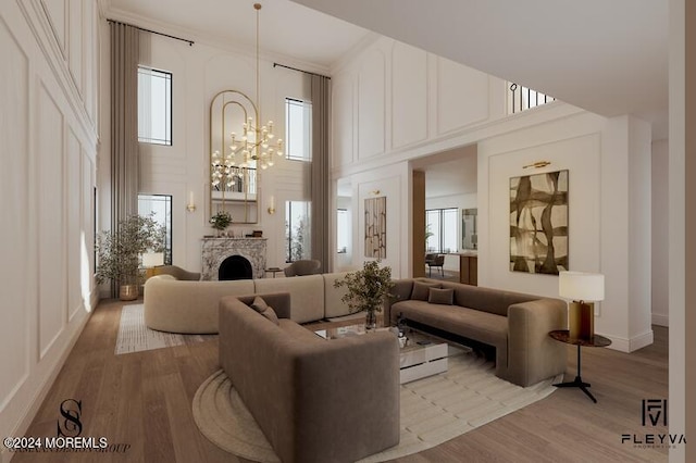 living room featuring wood-type flooring, an inviting chandelier, a towering ceiling, and crown molding