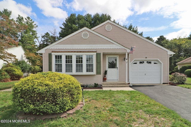 view of front facade with a garage and a front lawn