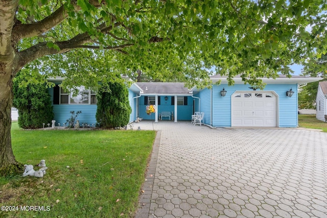 view of front of house featuring a garage and a front lawn