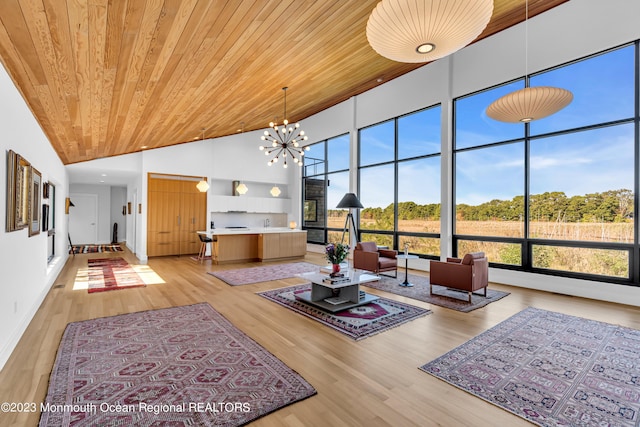 living room with a notable chandelier, light hardwood / wood-style flooring, wood ceiling, and high vaulted ceiling