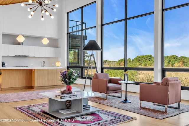 49 N Cherokee Ln, Brick, NJ 08724 - living area featuring plenty of natural light, floor to ceiling windows, light wood finished floors, and a towering ceiling