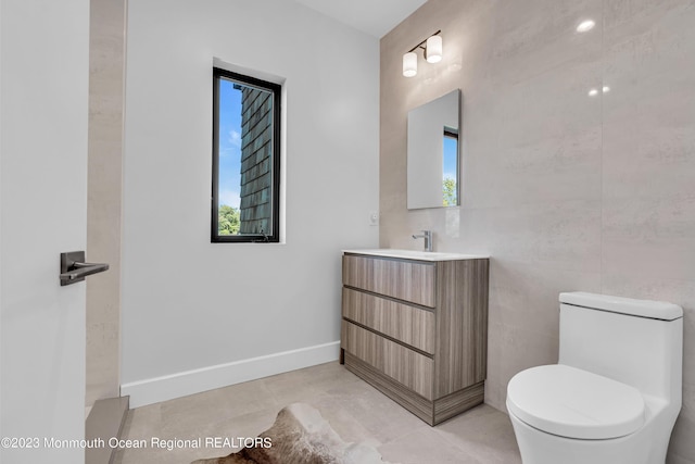 49 N Cherokee Ln, Brick, NJ 08724 - bathroom featuring toilet, vanity, tile patterned floors, and tile walls