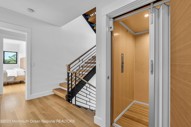 49 N Cherokee Ln, Brick, NJ 08724 - staircase with elevator, wood finished floors, and baseboards