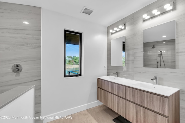 49 N Cherokee Ln, Brick, NJ 08724 - full bathroom with walk in shower, baseboards, tile walls, double vanity, and wood finished floors