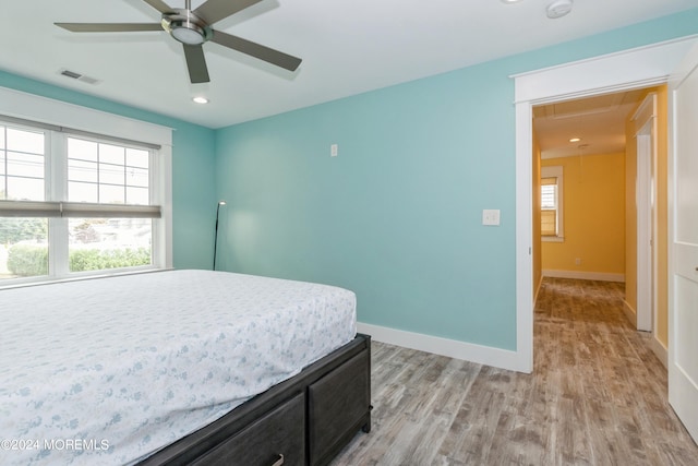 bedroom with light hardwood / wood-style flooring and ceiling fan