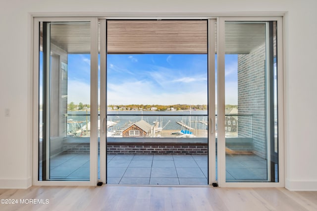 interior space featuring a water view and wood-type flooring