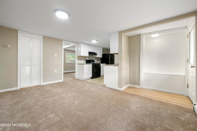 unfurnished living room featuring light colored carpet