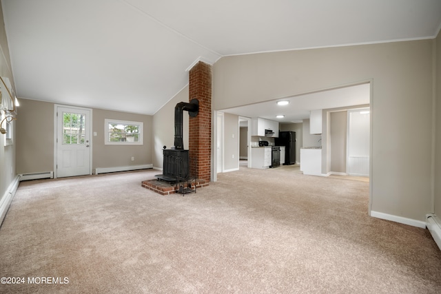 unfurnished living room with light carpet, baseboard heating, vaulted ceiling, and a wood stove