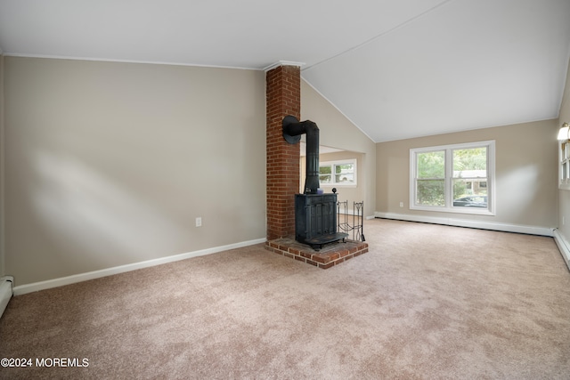 unfurnished living room with carpet floors, lofted ceiling, and a wood stove