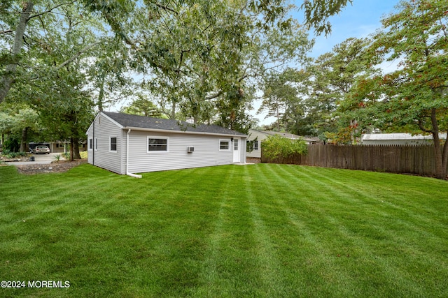 back of house featuring a lawn